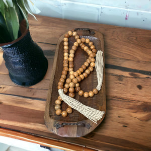Boho wood bead garland styled on farmhouse coffee table