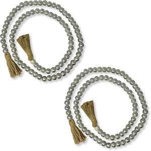 Two beaded necklaces with tassels on a white background
