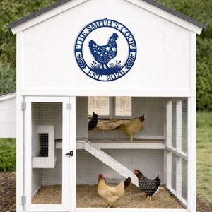 White chicken coop with a blue sign on the door, featuring three chickens inside.