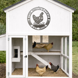 White chicken coop with a circular metal sign featuring a chicken design, and three chickens inside.