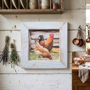 Framed picture of chickens on a rustic kitchen wall with herbs and pots.
