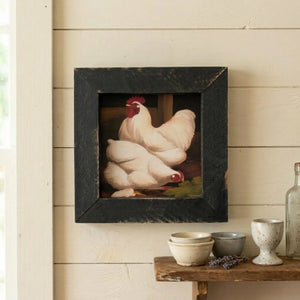Framed artwork of a rooster on a wall with rustic decor below.