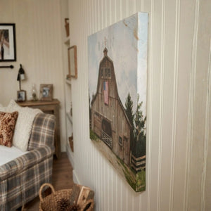 Painting of a wooden cabin on a wall in a living room.