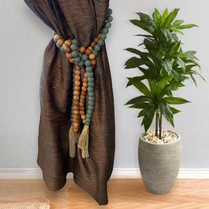 Wooden bead garland used as curtain tieback
