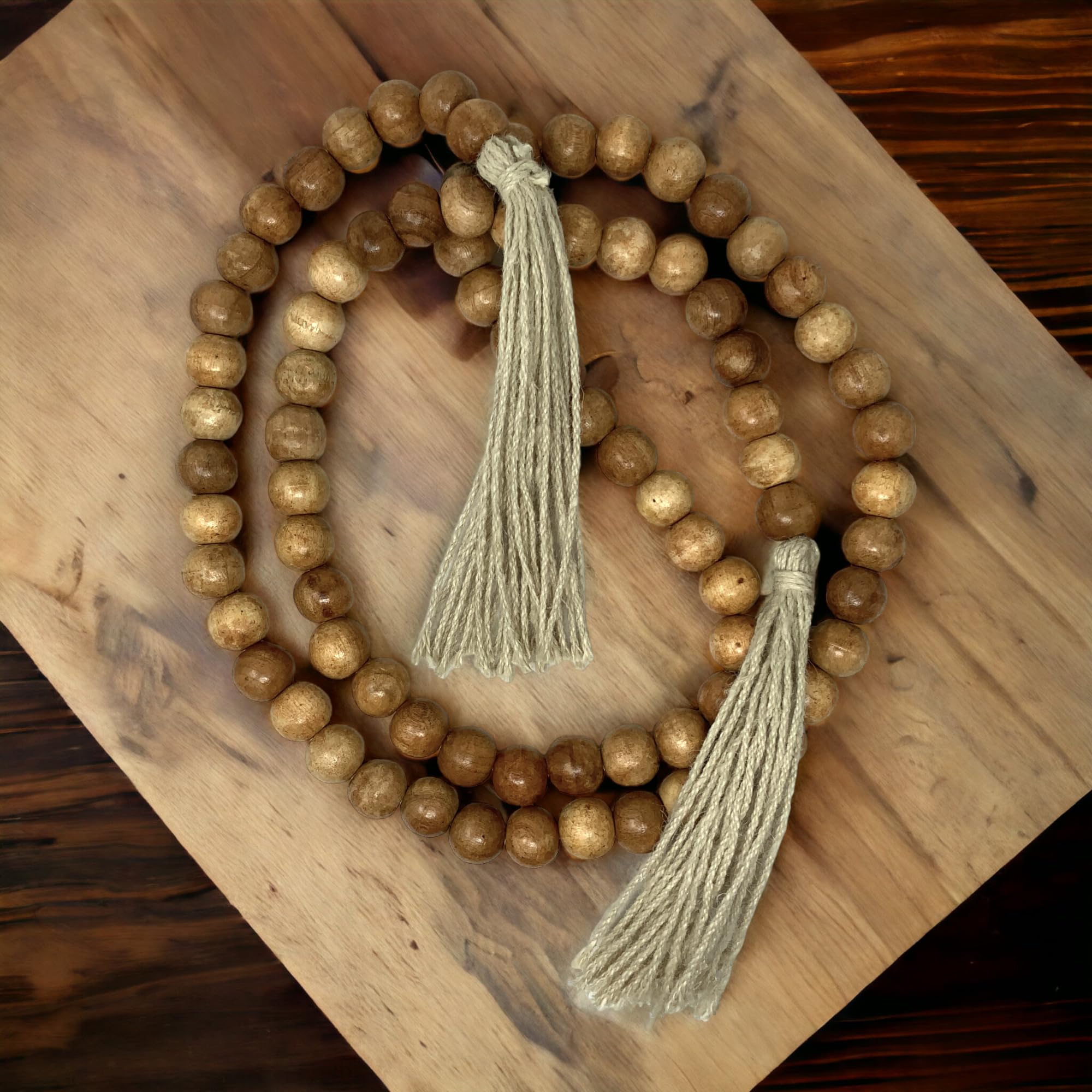 Wooden beaded necklace with tassels on a wooden surface