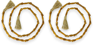 Set of three decorative necklaces with tassels on a white background