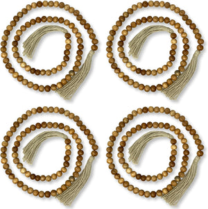 Four wooden beaded necklaces with tassels on a white background