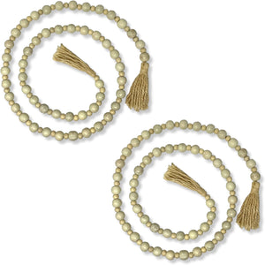 Set of two beige beaded garlands with tassels on a white background