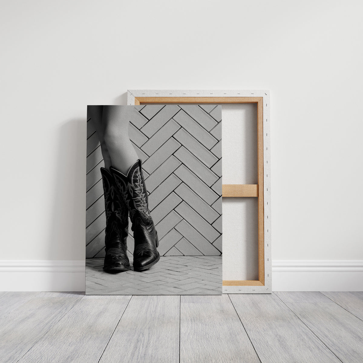 Black and white cowboy boots art in black framed canvas