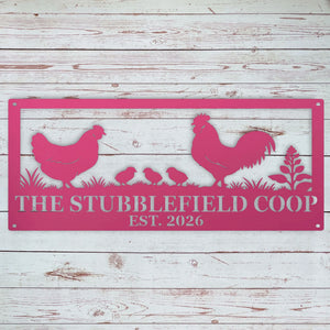 A rectangular pink metal wall sign with a chicken, rooster, chicks, and plant silhouette, plus the text 'THE STUBBLEFIELD COOP EST. 2026,' shown against a whitewashed wood plank background.