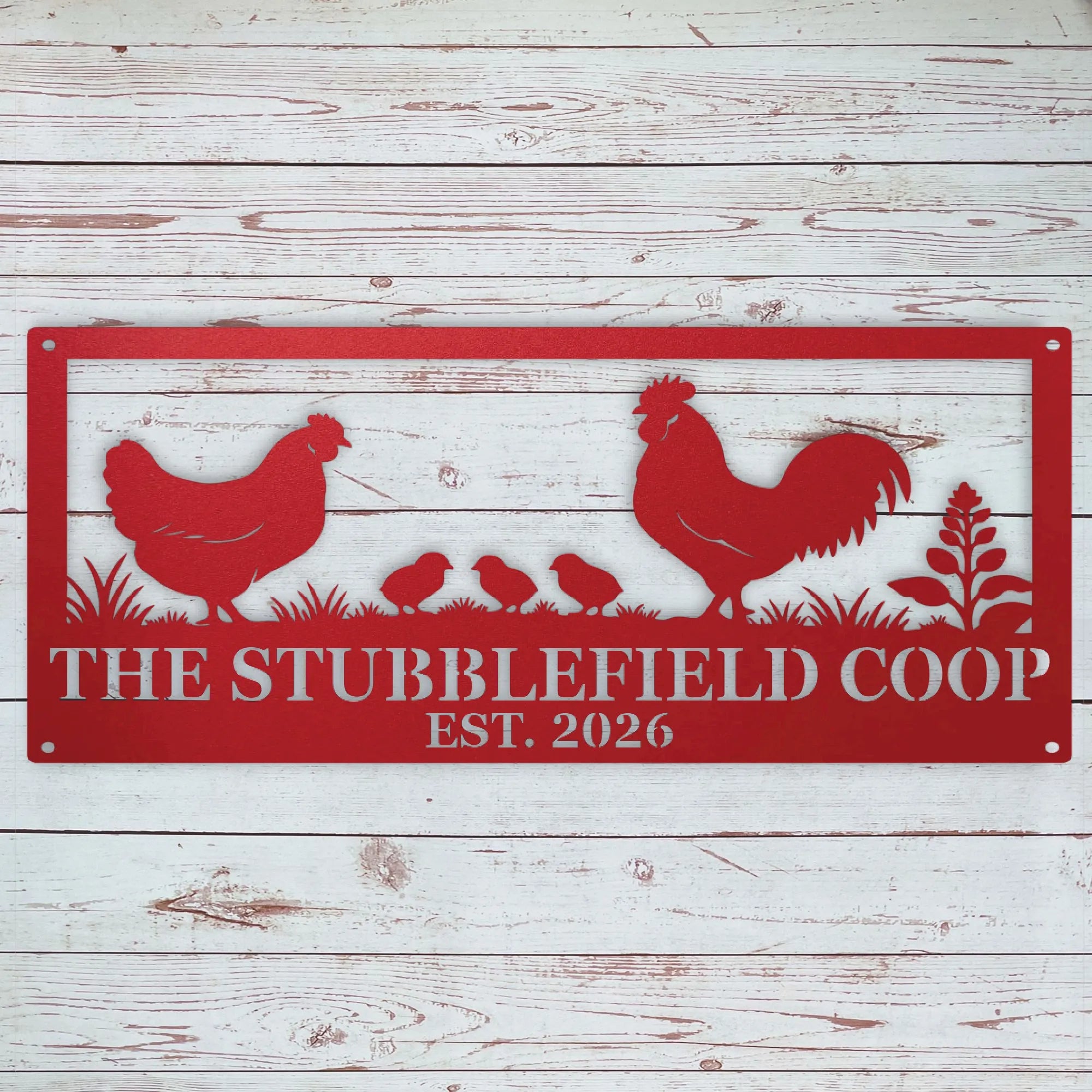 A red metal sign with a silhouette of a rooster, hen, chicks, and grass, featuring personalized name and year, displayed against a white rustic wood plank background.