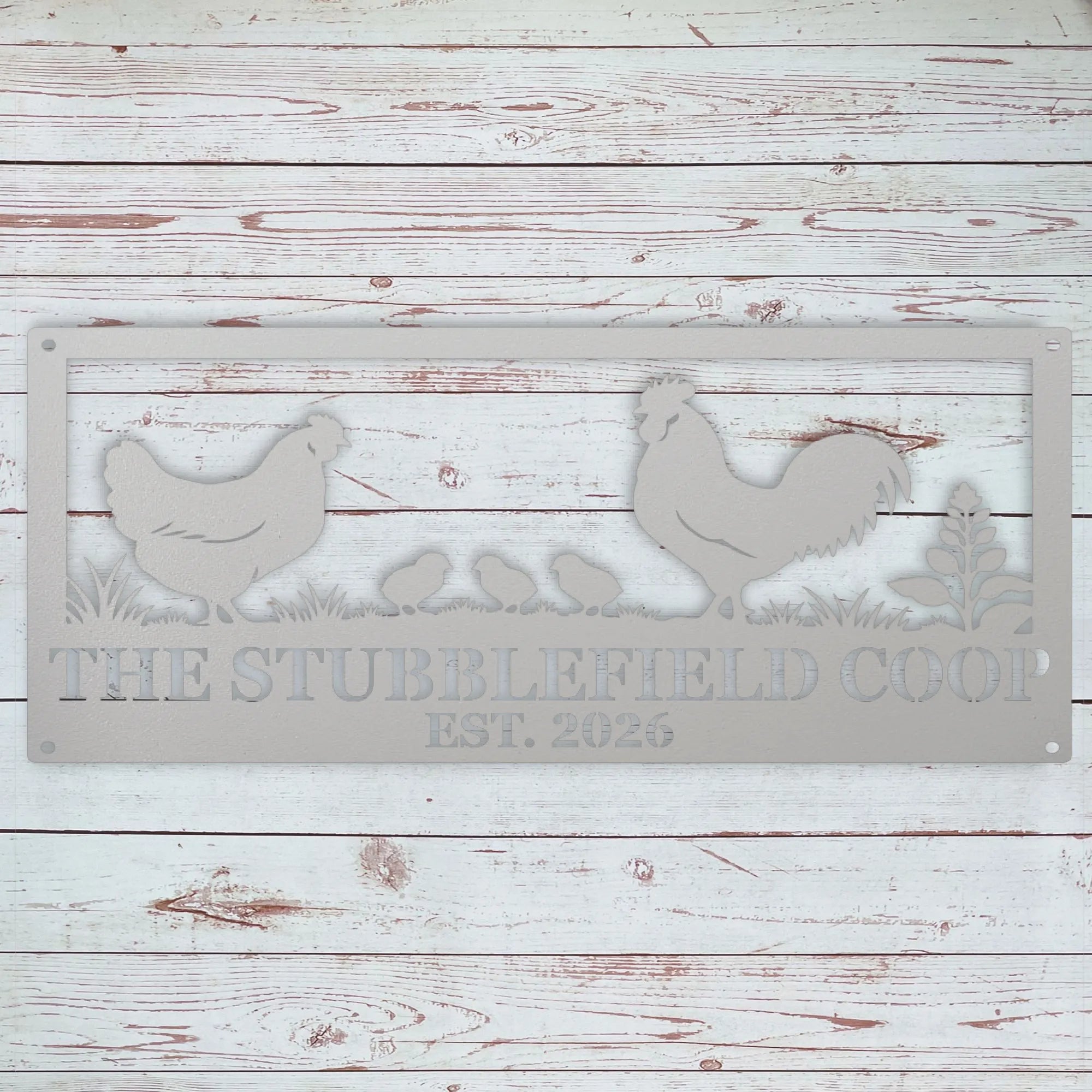 A rectangular metal sign with a distressed gray finish, featuring silhouettes of a rooster, hen, chicks, and plants, with the text 'THE STUBBLEFIELD COOP EST. 2026' cut out.