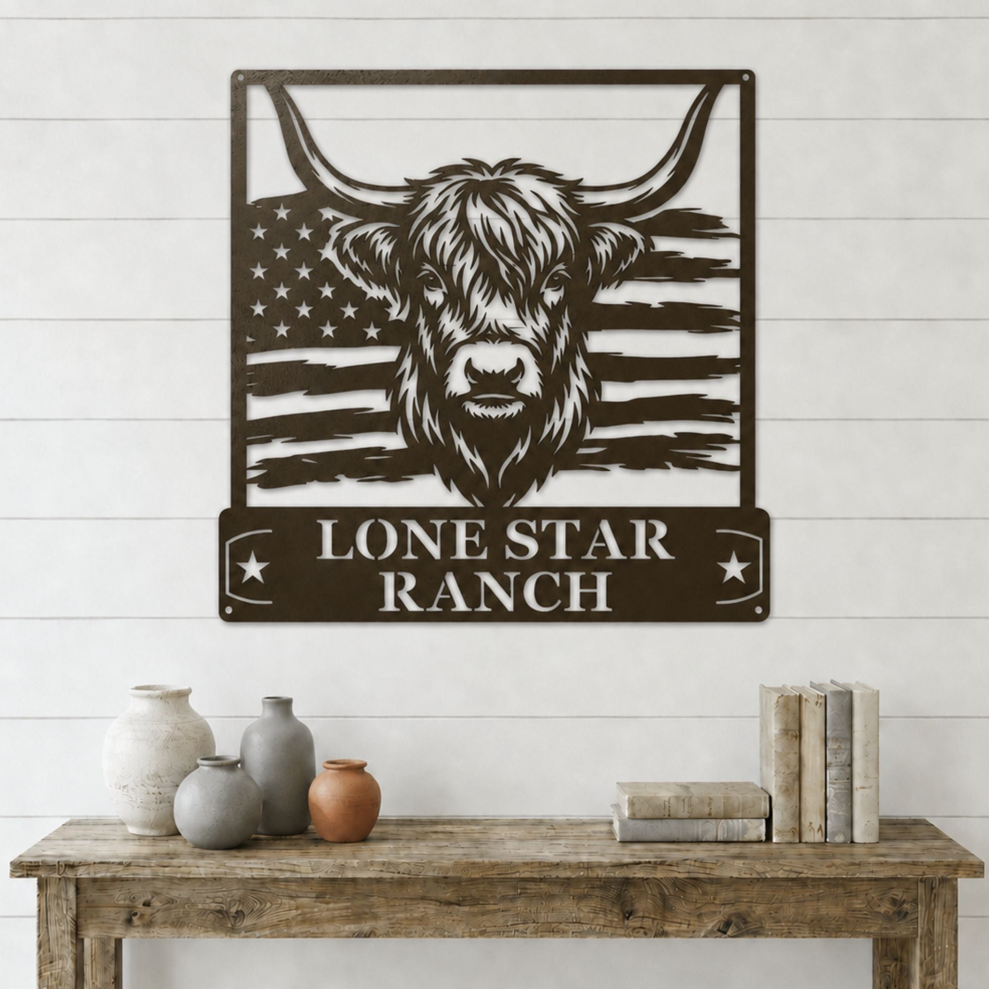 Metal wall art with a cow design and 'Lone Star Ranch' text on an American flag background, displayed on a white wooden wall.