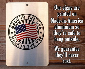 Made-in-America aluminum sign with American flag design on a wooden background