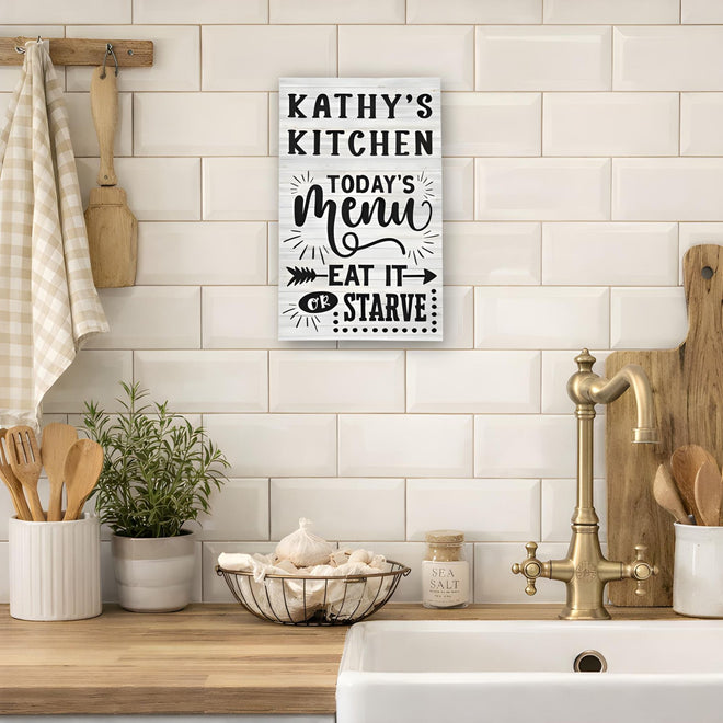  Custom Kitchen sign on a tiled wall above a kitchen counter with utensils and plants.