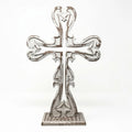 Farmhouse cross styled on mantel creating a warm and peaceful space