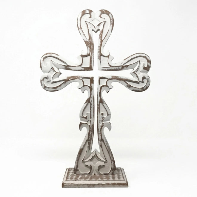 Farmhouse cross styled on mantel creating a warm and peaceful space