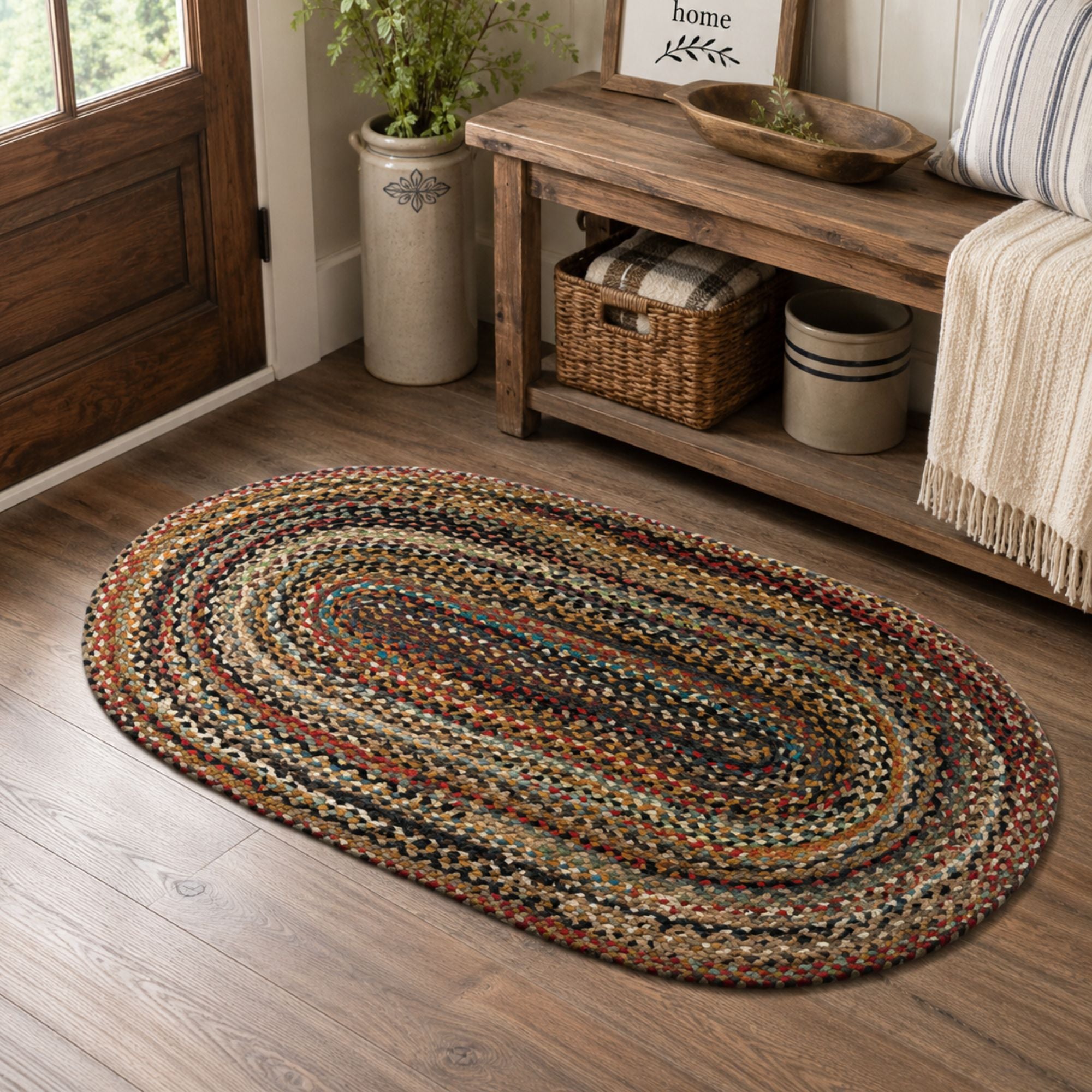 27 x 45 inch multicolor oval braided jute rug styled in a warm farmhouse entryway with a rustic wood bench, woven basket storage, and neutral decor.