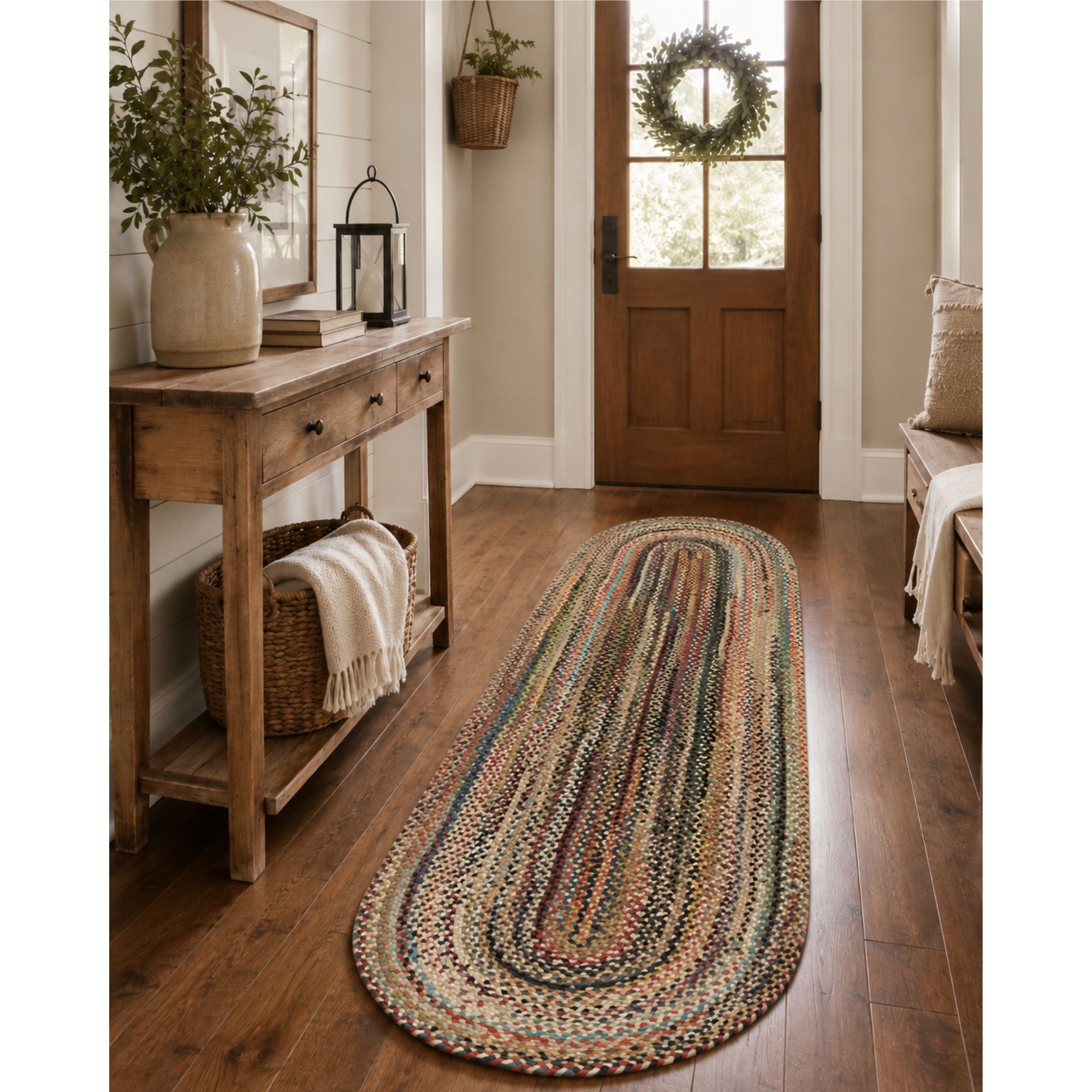 2 x 8 foot multicolor braided oval hallway runner rug in a warm farmhouse entryway with wood flooring, rustic console table, woven basket, and natural greenery.