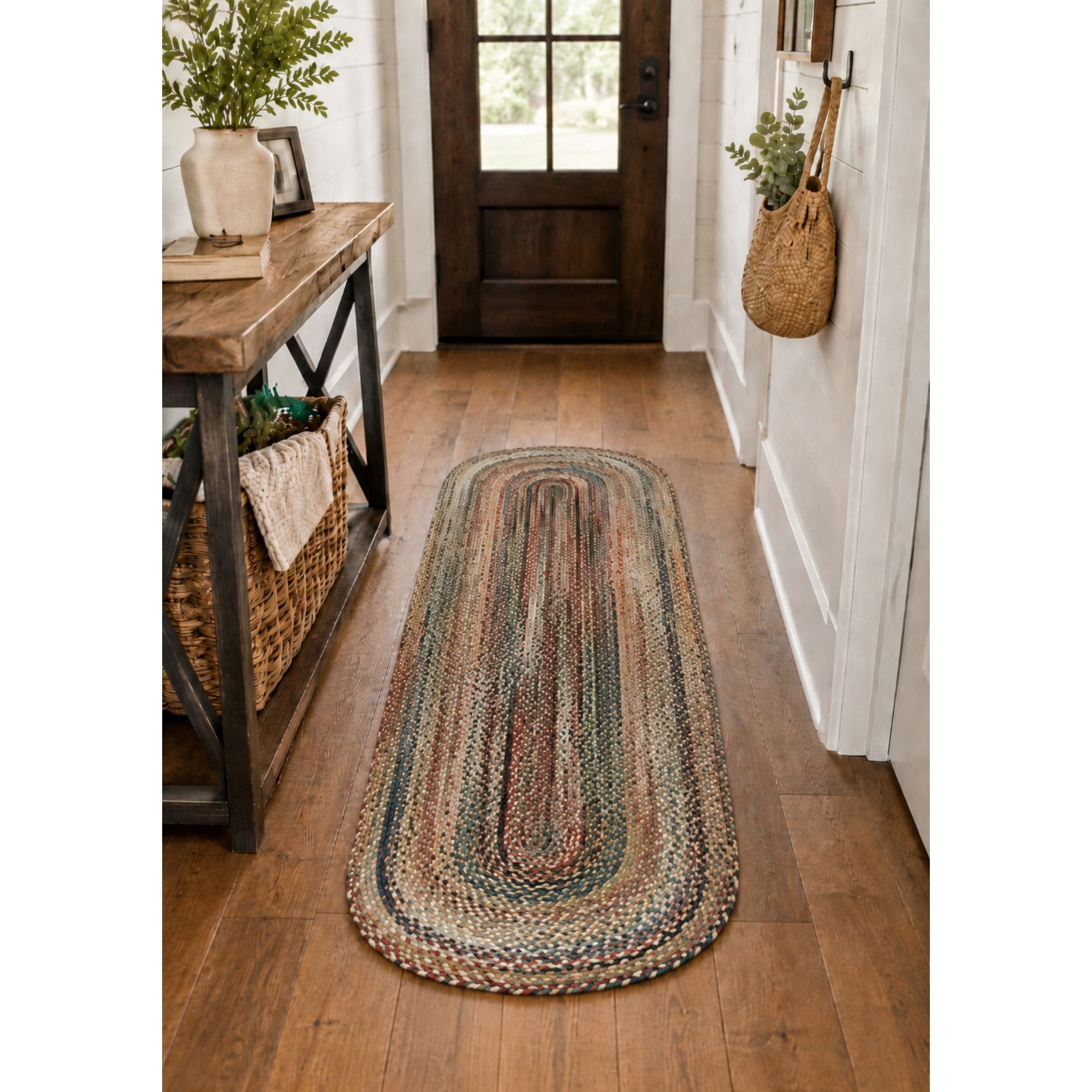2 x 6 foot multicolor braided oval runner rug styled in a cozy farmhouse hallway with warm wood flooring, rustic console table, woven basket, and natural greenery.