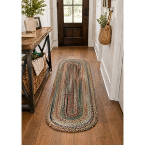 2 x 6 foot multicolor braided oval runner rug styled in a cozy farmhouse hallway with warm wood flooring, rustic console table, woven basket, and natural greenery.