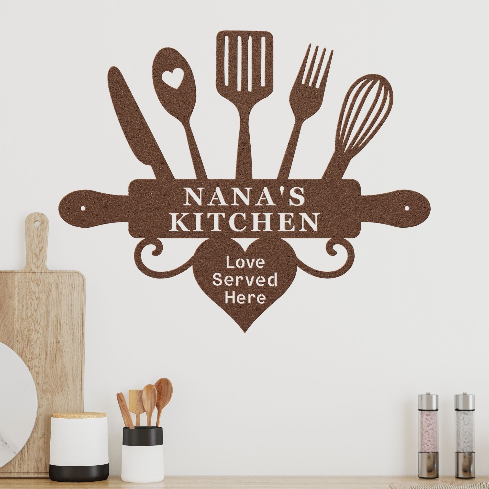 Decorative wall decal with kitchen utensils and 'Nana's Kitchen' text on a white wall.