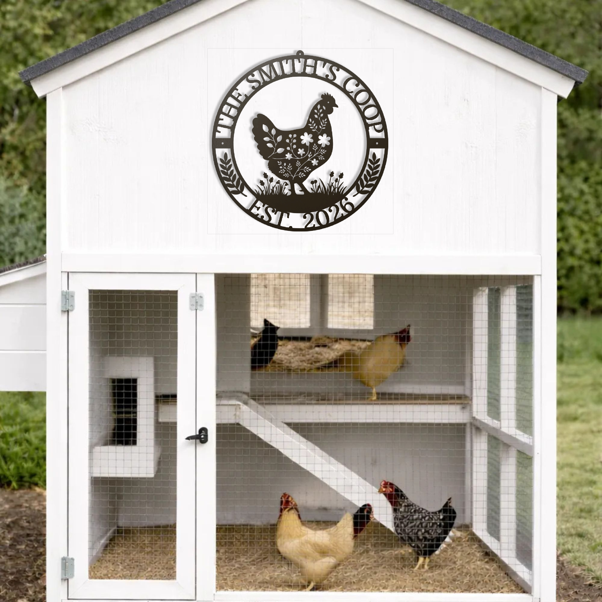 White chicken coop with a circular sign featuring a rooster design, and three chickens inside.