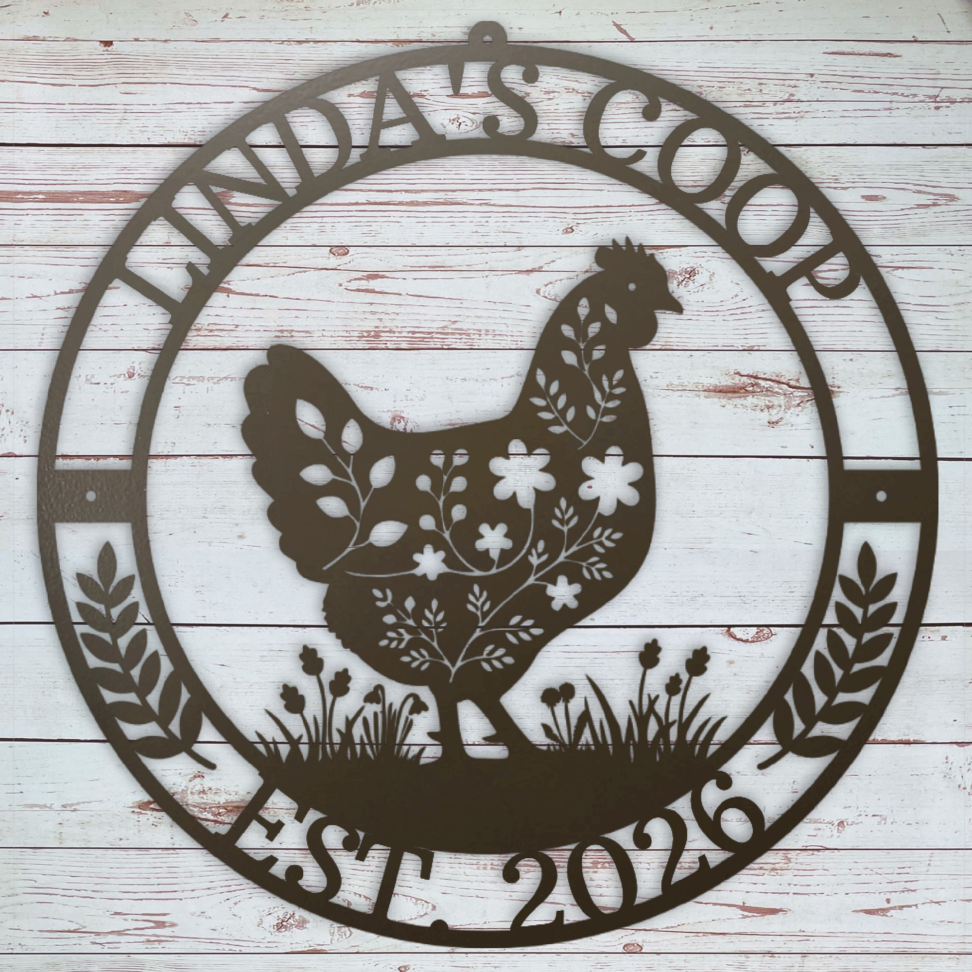 Decorative metal sign with a rooster design and 'Winda's Coop Est. 2026' text on a wooden background.