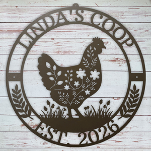 Decorative metal sign with a rooster design and 'Winda's Coop Est. 2026' text on a wooden background.