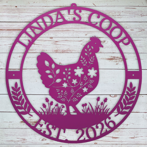 Decorative pink metal sign with a chicken design and 'Winda's Coop' text on a wooden background