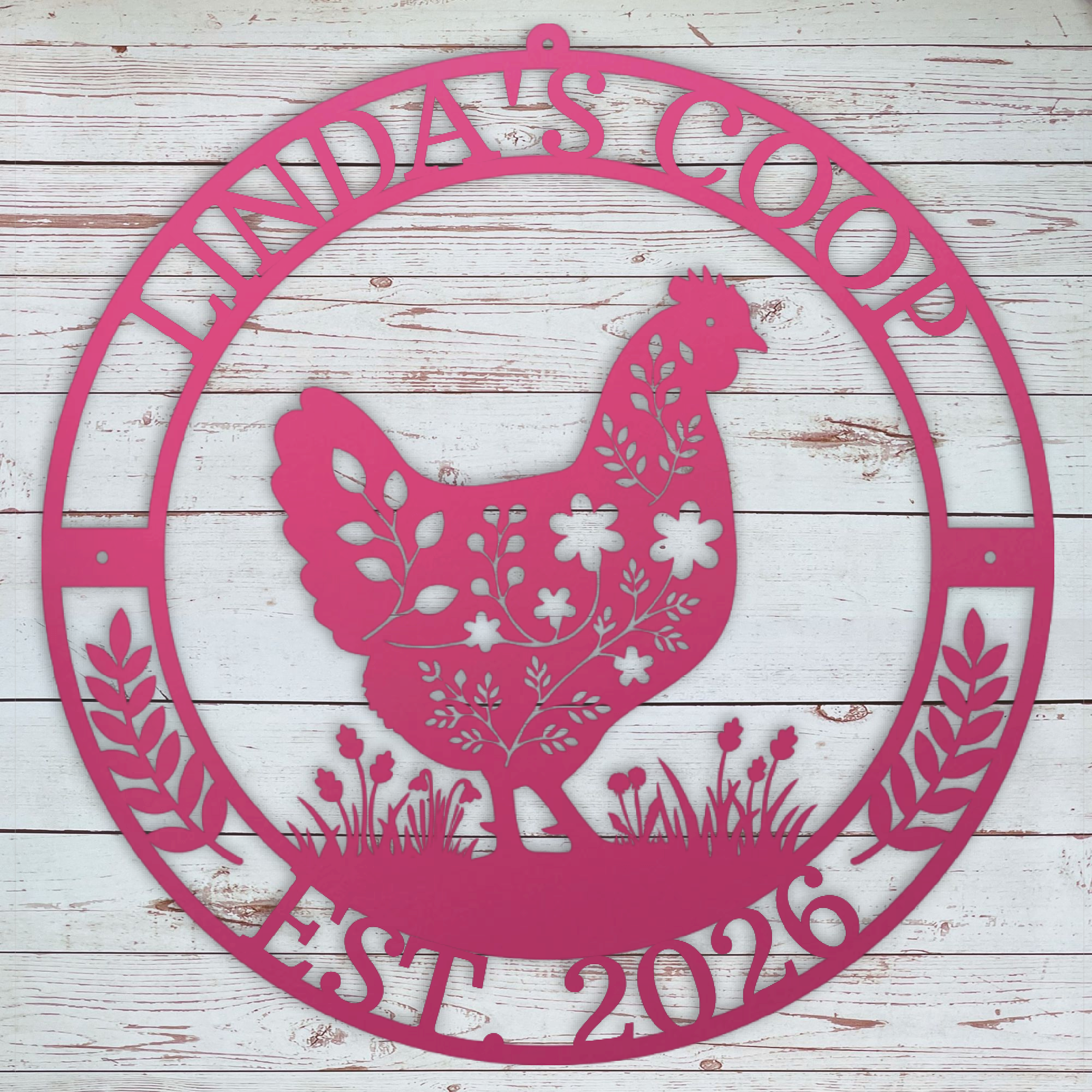 Decorative metal pink sign with a chicken silhouette and text on a wooden background