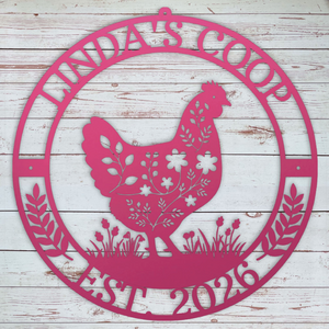 Decorative metal pink sign with a chicken silhouette and text on a wooden background