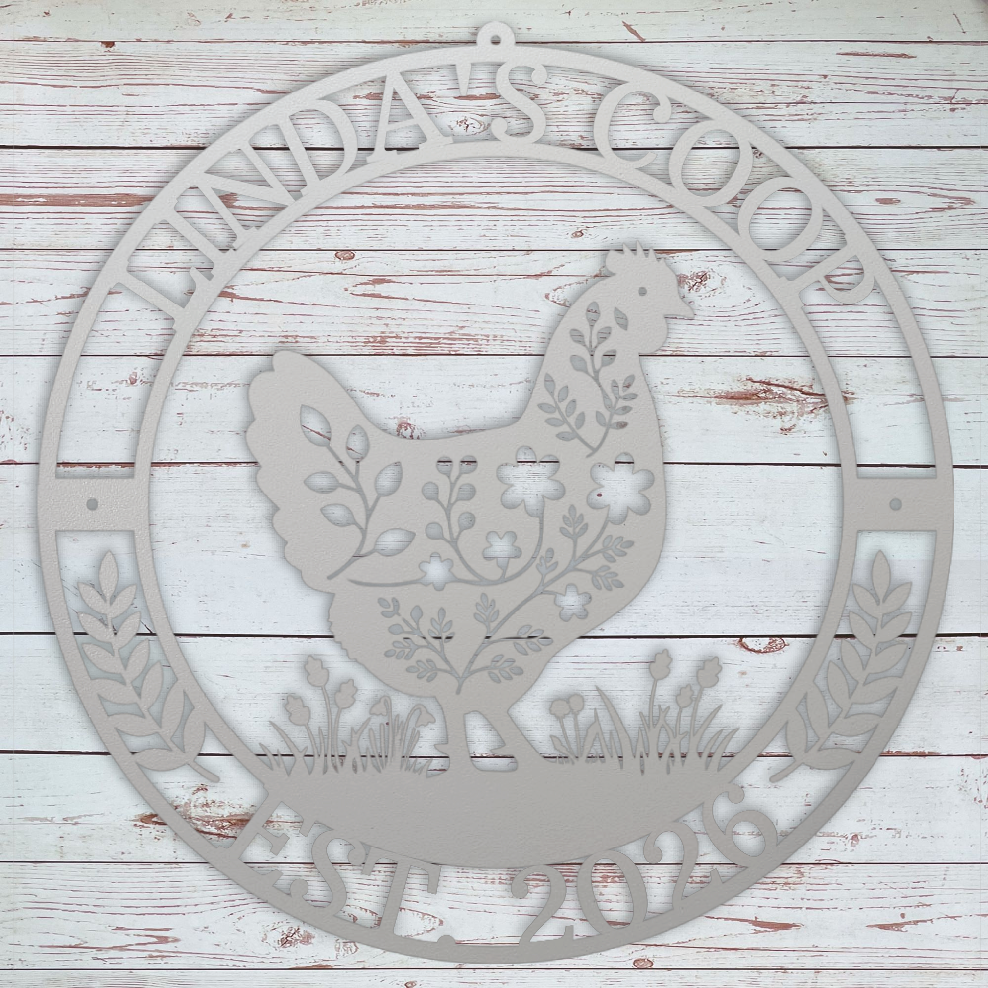 Decorative metal sign with a rooster design and 'Linda's Coop' text on a wooden background