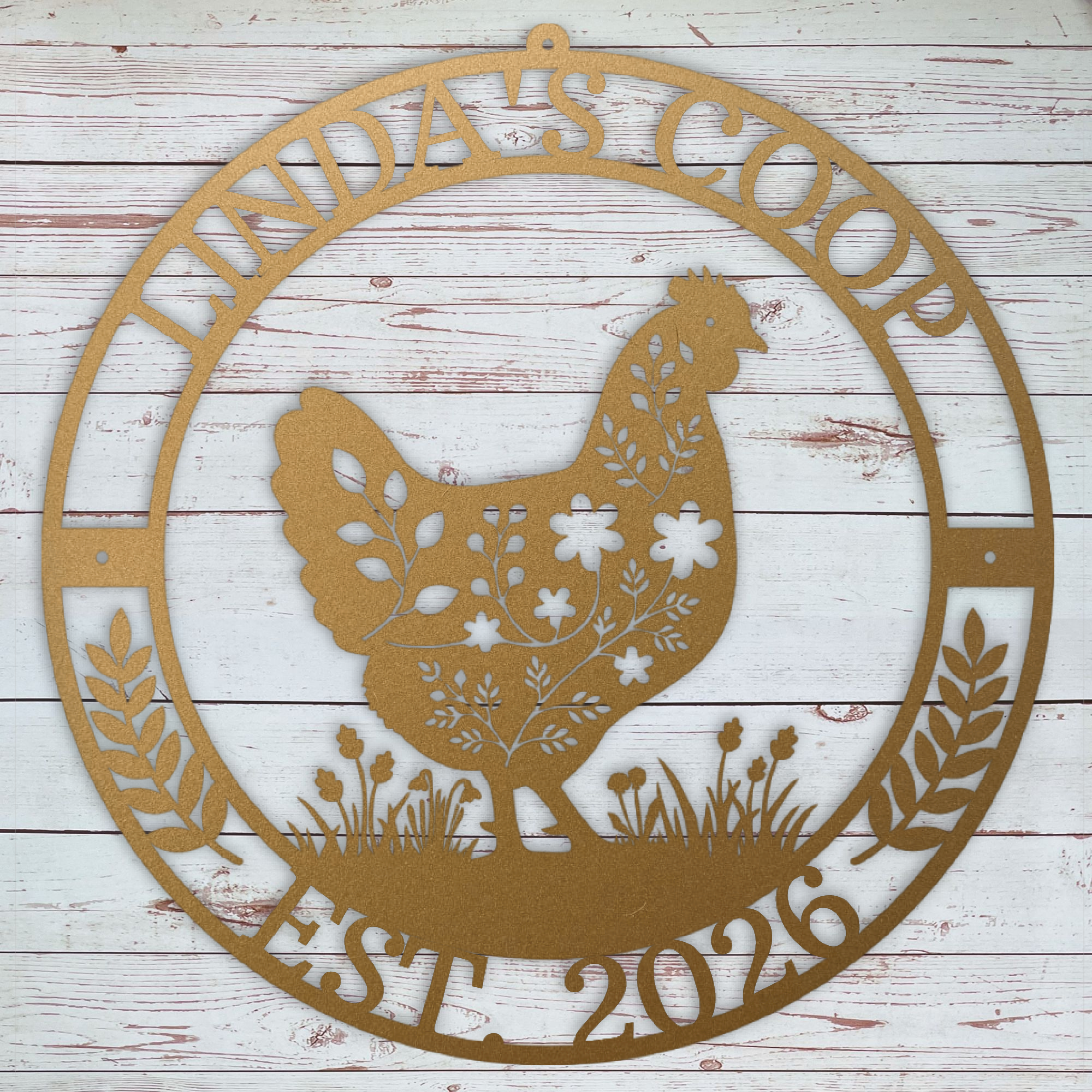 Decorative copper colored metal sign with chicken silhouette and text on a wooden background