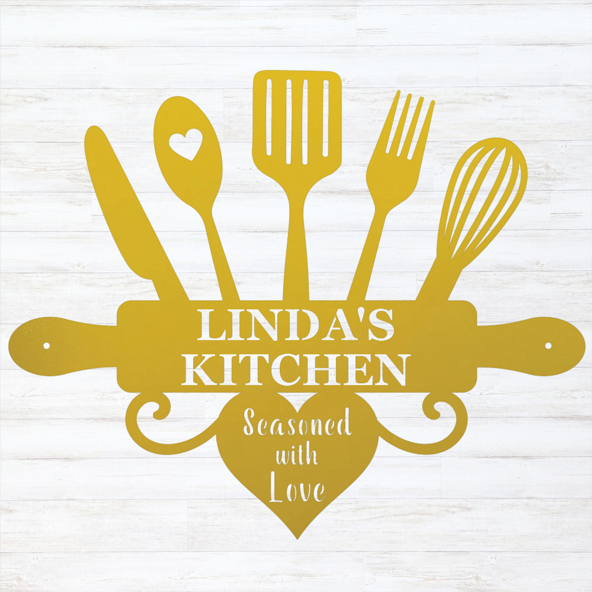 A yellow kitchen-themed decorative sign or silhouette design featuring a knife, spoon with a heart, spatula, fork, whisk, rolling pin, and heart shape with the text 'LINDA'S KITCHEN' and 'Seasoned with Love,' shown on a white wood-plank background.
