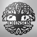 Decorative metal wall art with tree design on a gray background