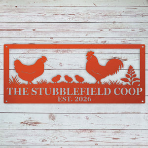 A rectangular red metal sign with cutout farm animal silhouettes and the text 'THE STUBBLEFIELD COOP EST. 2026' mounted against a whitewashed wood plank background.