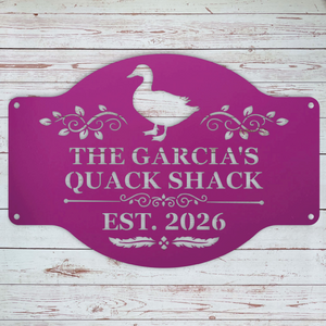 Metal duck coop sign purple shown on outdoor coop wall
