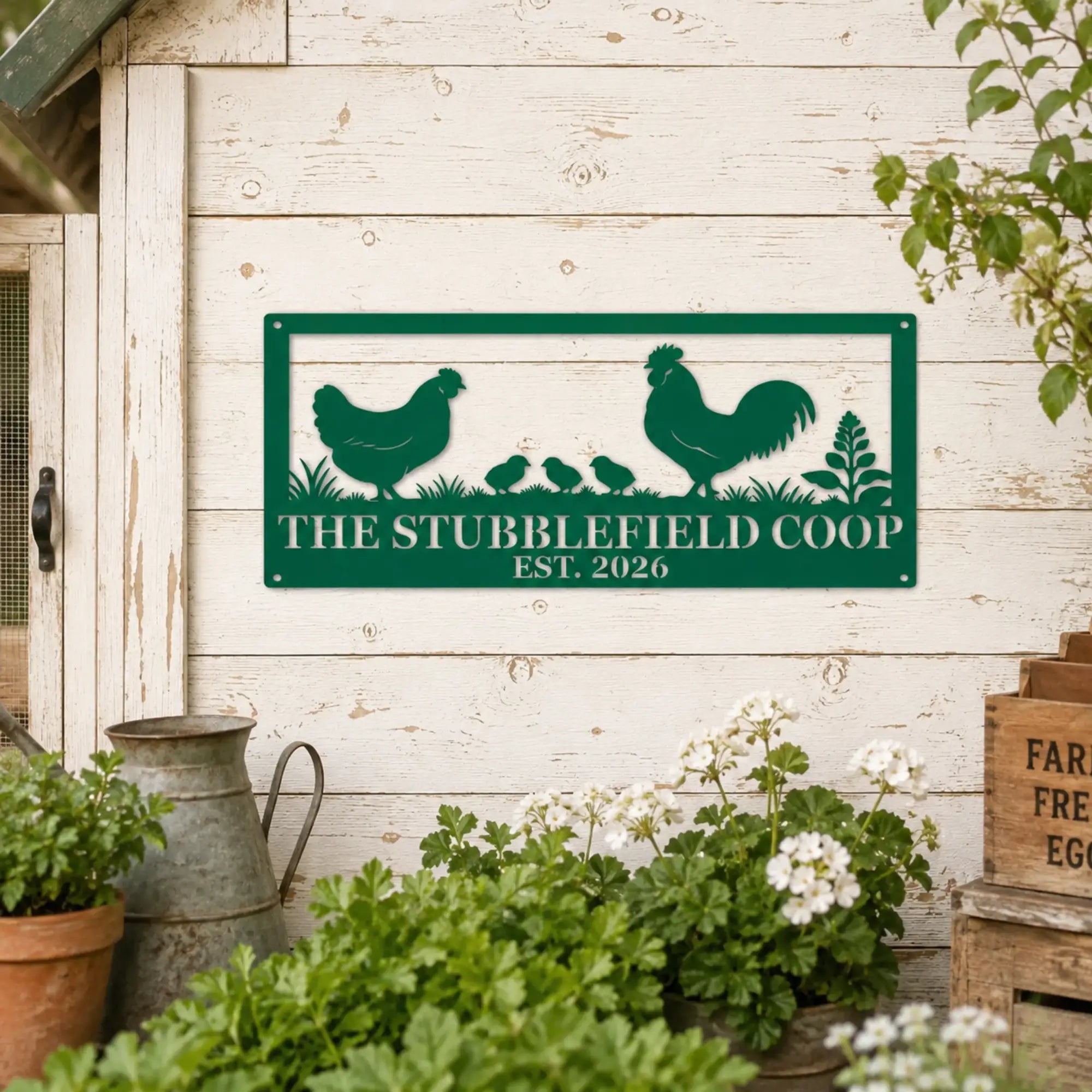 Personalized green chicken coop metal sign with hen, rooster, and chicks displayed on a rustic white farmhouse coop wall.