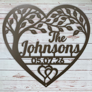 A heart-shaped metal wall sign with a tree silhouette, personalized with the text 'The Johnsons' and the date '05.07.