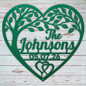 A personalized green metal heart-shaped wall sign featuring a tree silhouette, the text 'The Johnsons', the date '05.07.