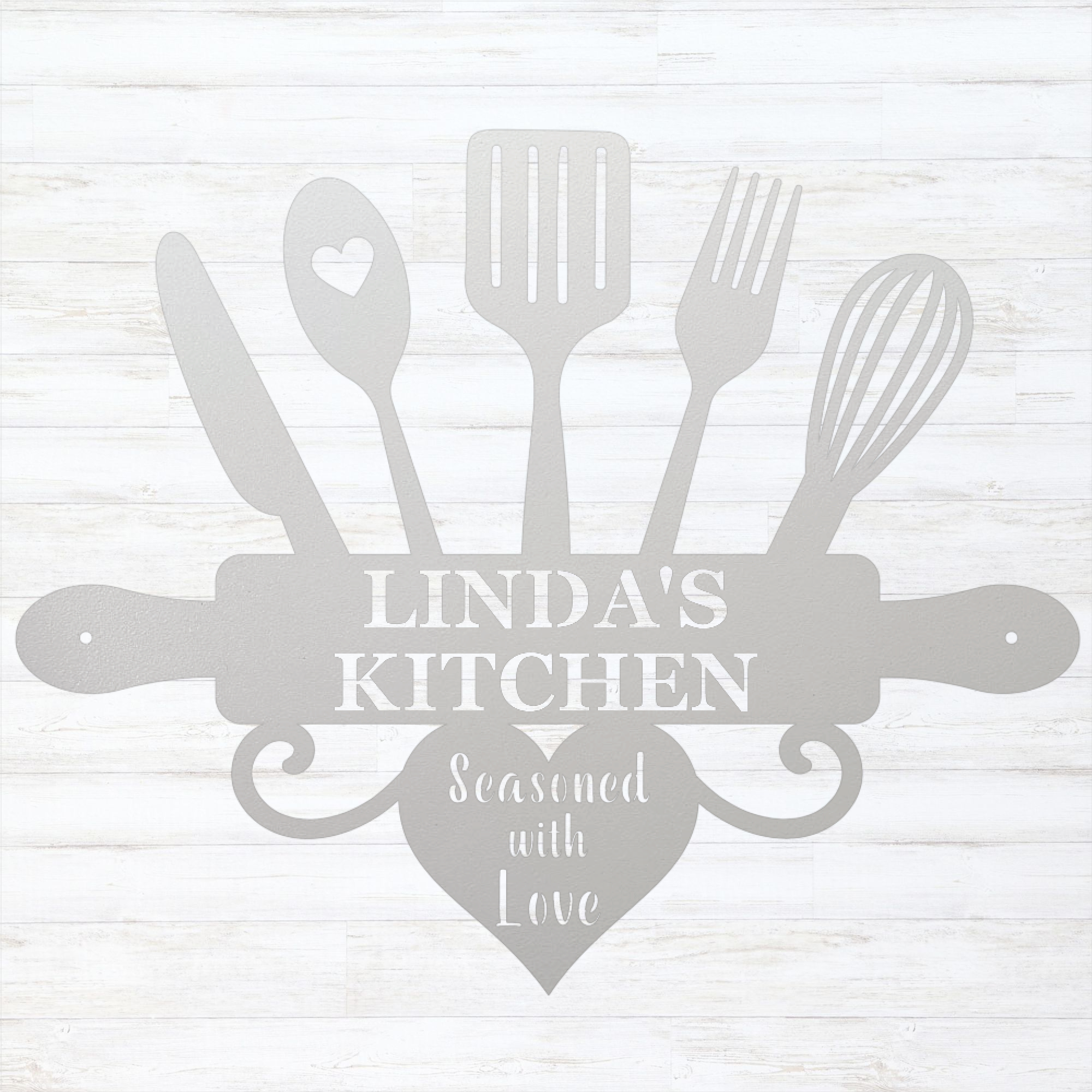 A white personalized kitchen wall sign featuring silhouettes of kitchen utensils and a rolling pin with the text 'LINDA'S KITCHEN' and 'Seasoned with Love' in white on a light gray background.