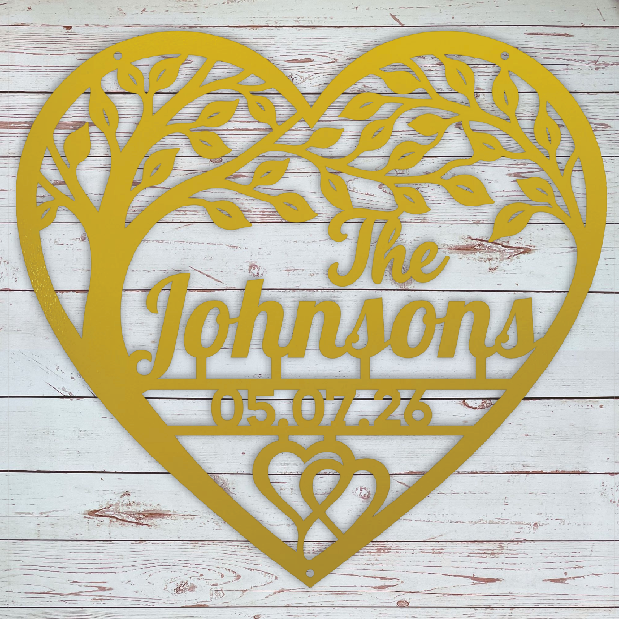 A yellow personalized heart-shaped metal wall sign with a tree silhouette, featuring the name the date.